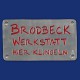 Werkstatt-Türschild mit rotem Hintergrund