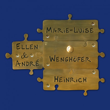 Puzzle Türschild aus Messing mit vier Puzzleteilen und Klingeltaster